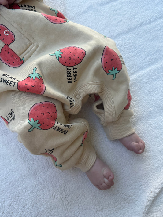 Close-up of Berry Sweet kids coverall showing strawberry print and ribbed ankle cuffs.