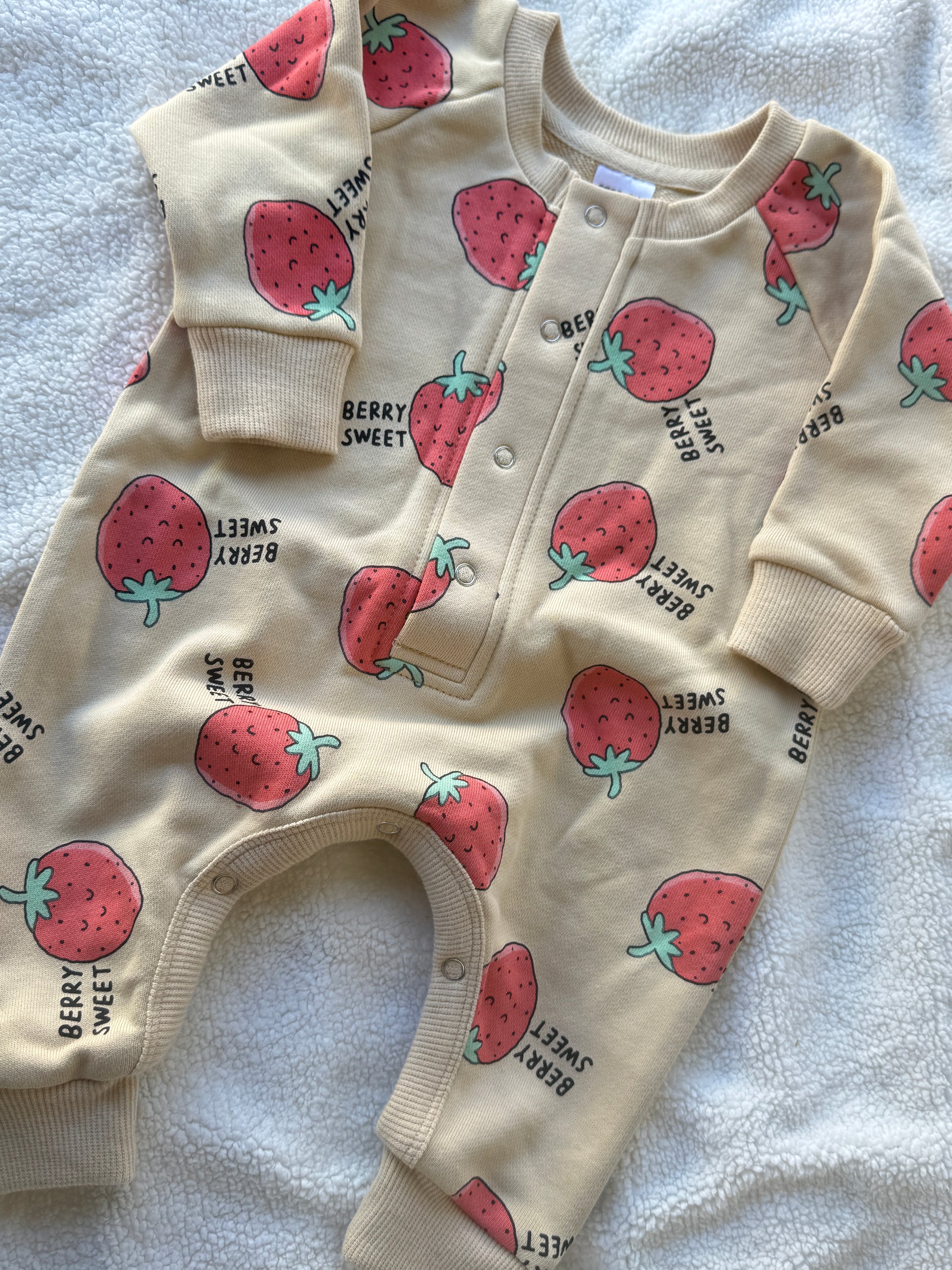 Berry Sweet kids coverall with strawberry print, snap buttons and ribbed cuffs by Step By Step Co.